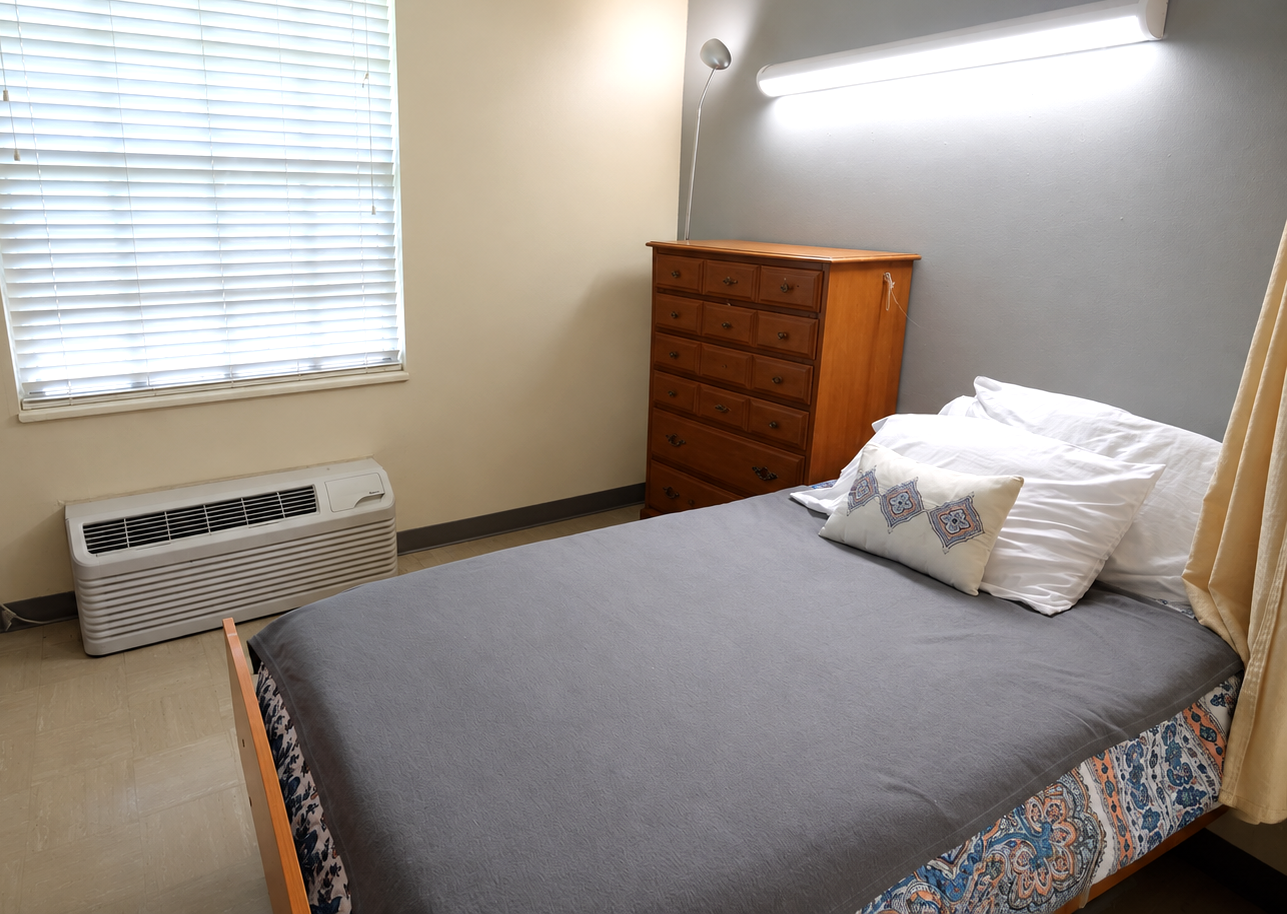 Diversicare resident bedroom with a window and dresser. 
