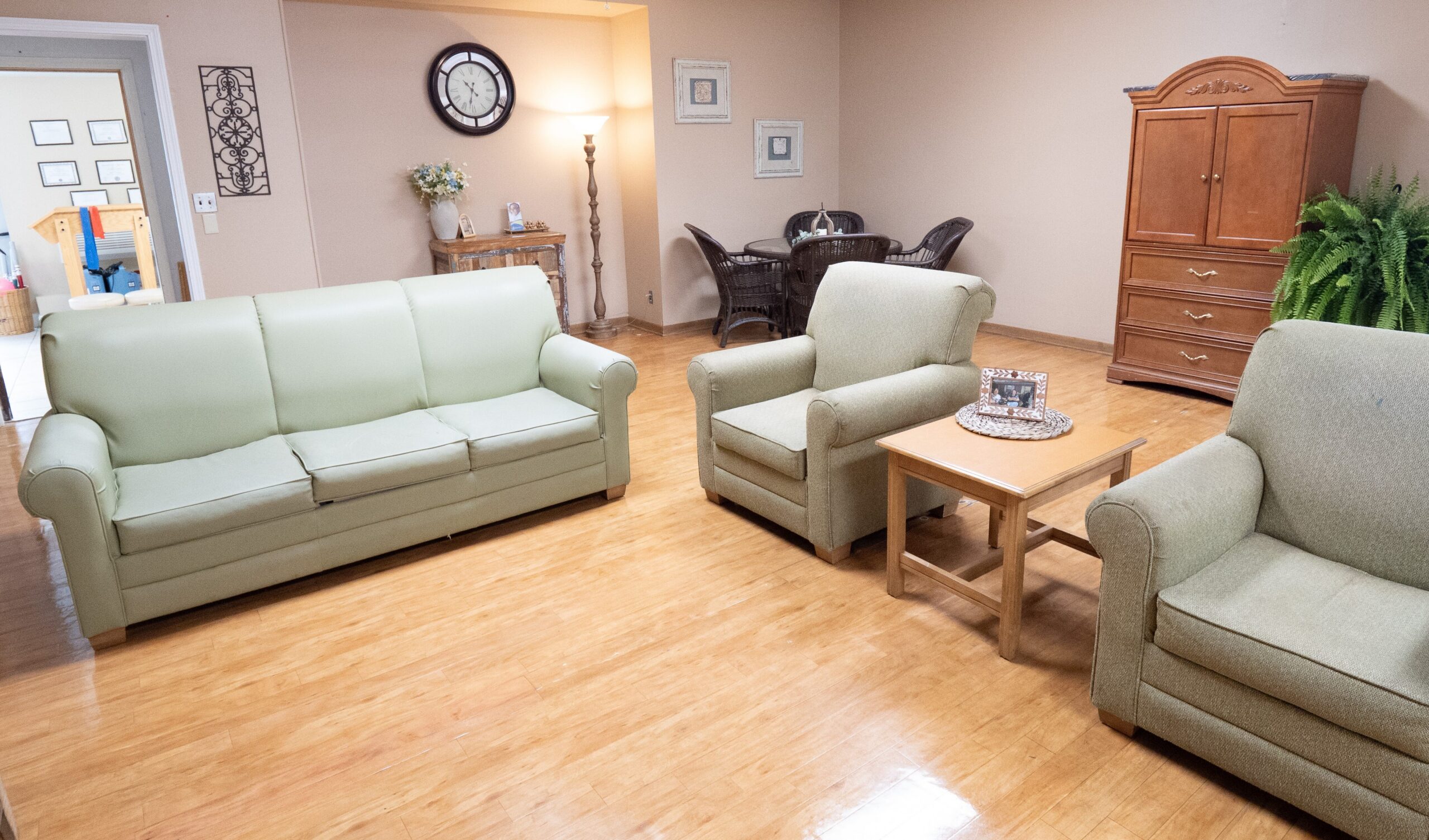 Comfortable living room at Diversicare of Tylertown featuring sofas, armchairs, and a coffee table for residents and visitors.