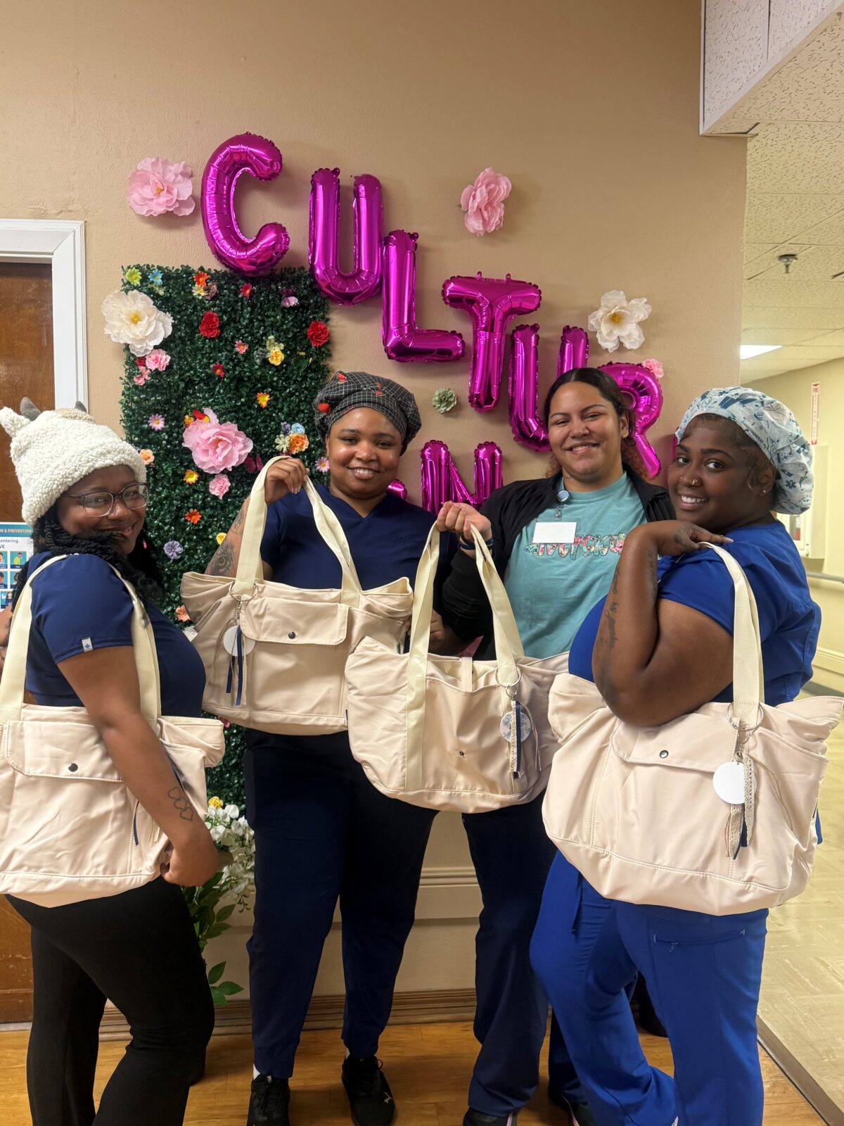 Diversicare of Tylertown team posing with tote bags and smiling. 