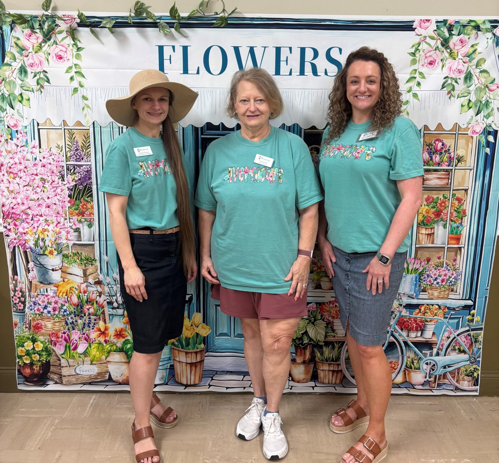 Three Diversicare team members standing together and smiling.